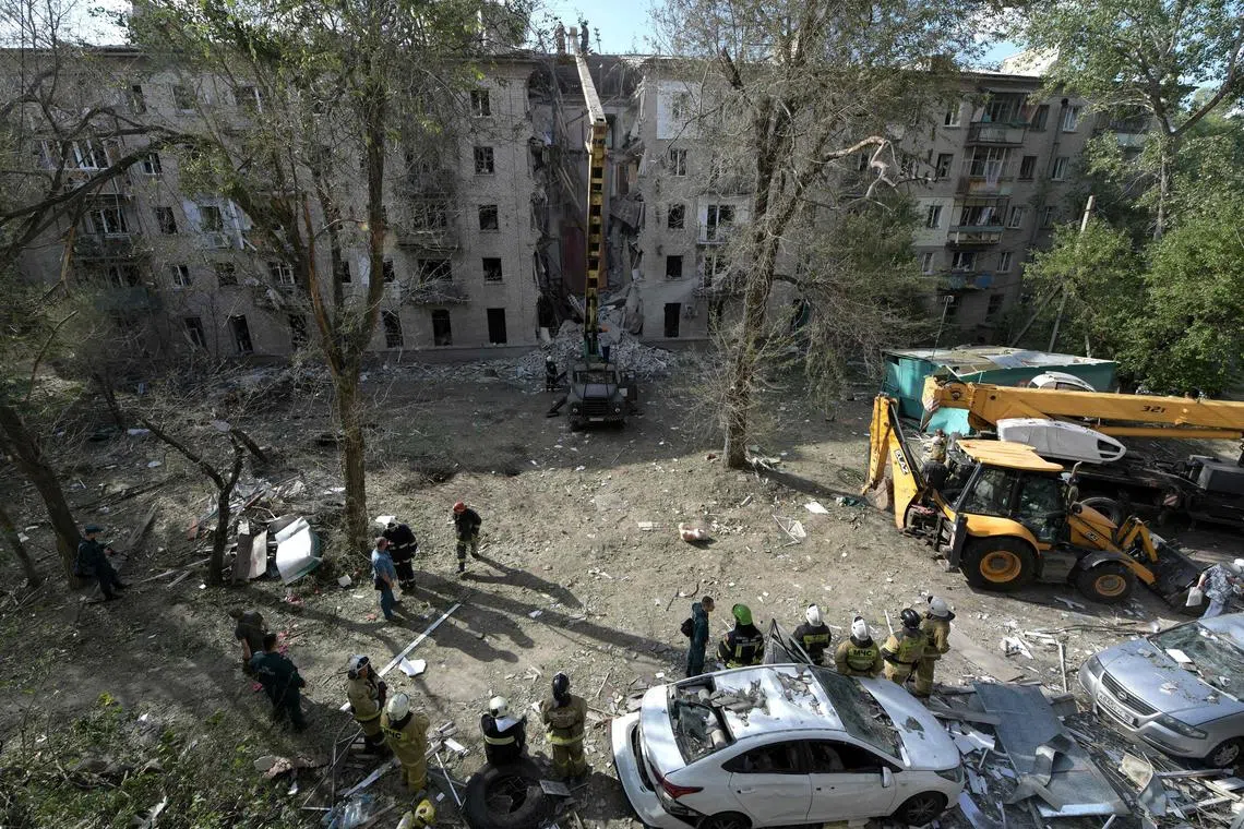 Rescuers work at the site of a missile attack in the Lugansk region, which Russia claims to have annexed.