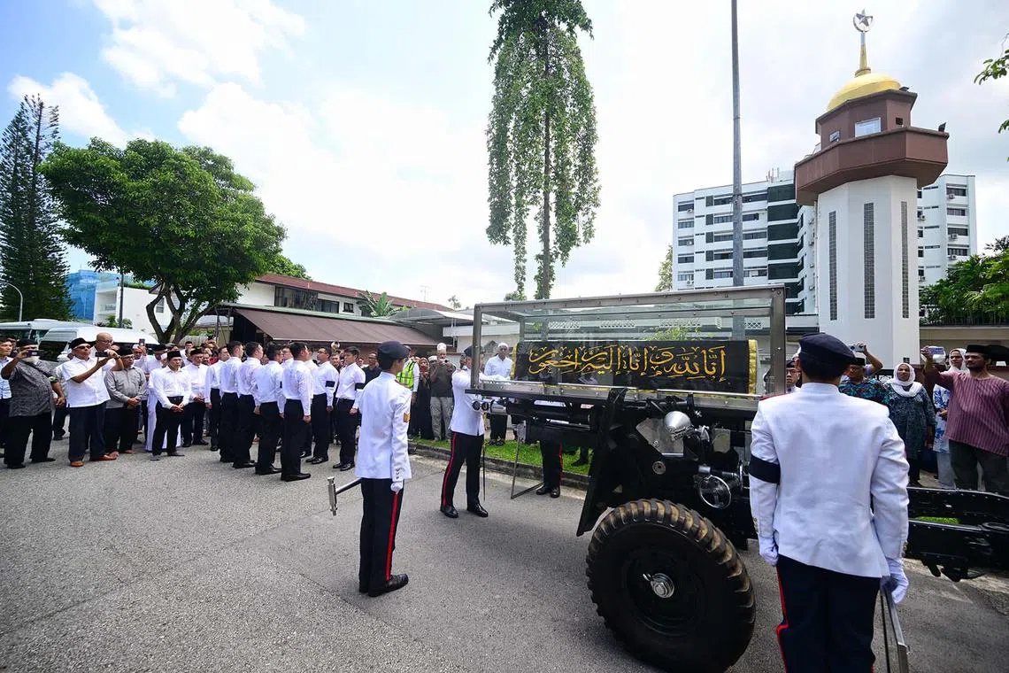 Pallbearers loading the casket of Puan Noor Aishah, Singapore’s former first lady and the widow of the country’s first president, Yusof Ishak, onto the gun carriage at Masjid Ba'alwie in Singapore on April 22, 2025. 