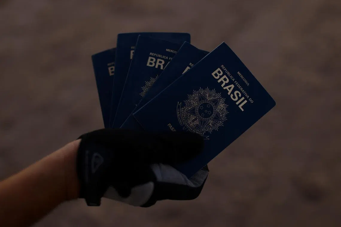 FILE PHOTO: A person shows passports from Brazil that were found on the banks of the Rio Bravo River, on the border between the U.S. and Mexico, in Ciudad Juarez, Mexico September 19, 2023. REUTERS/Jose Luis Gonzalez/File Photo