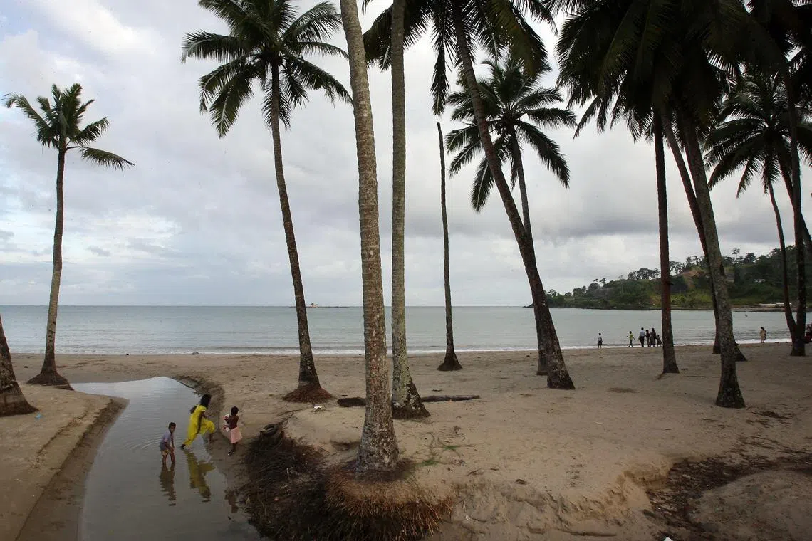 (FILES) In this file photo taken on September 6, 2007 a group of Indian tourists walk on a beach on South Andaman Island near Port Blair, capital of the Andaman and Nicobar Islands. - A US tourist was killed by arrows shot by tribesmen living in one of the world's most isolated regions tucked in India's Andaman and Nicobar Islands, police said November 21, 2018. (Photo by Desha-Kalyan CHOWDHURY / AFP)