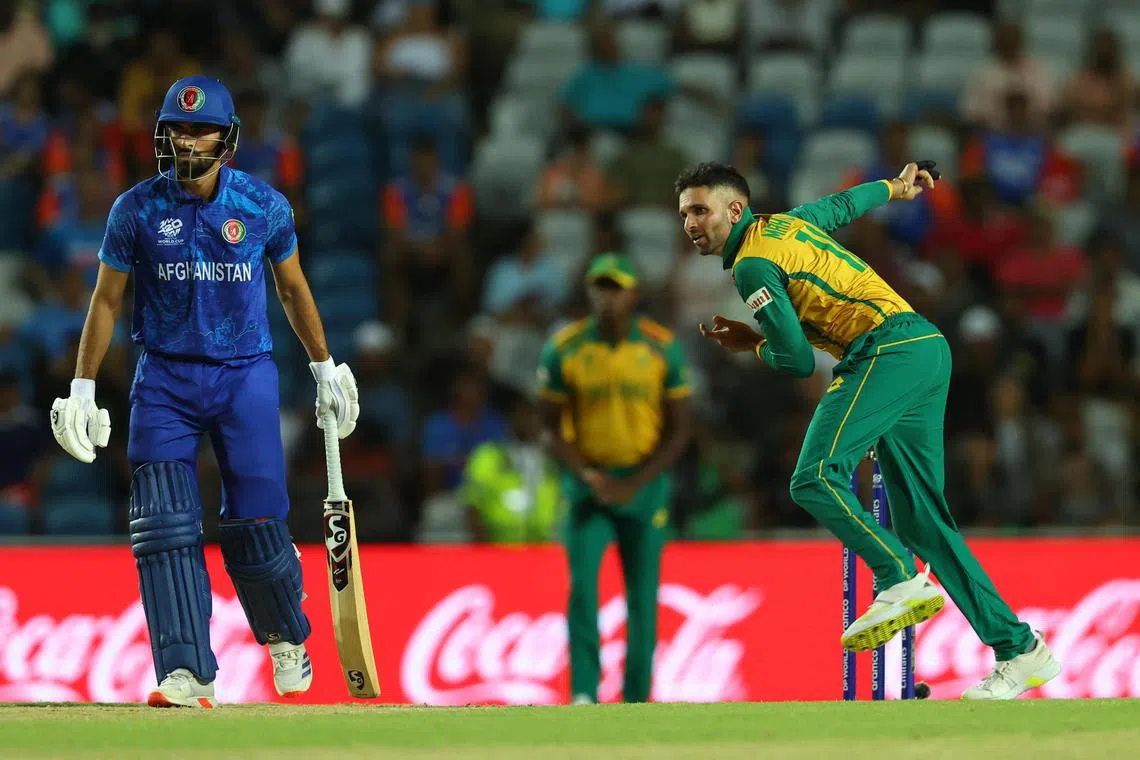 South Africa's Keshav Maharaj bowling in the cricket T20 World Cup semi-final against Afghanistan at the Brian Lara Stadium in  Tarouba, Trinidad and Tobago on June 26, 2024.