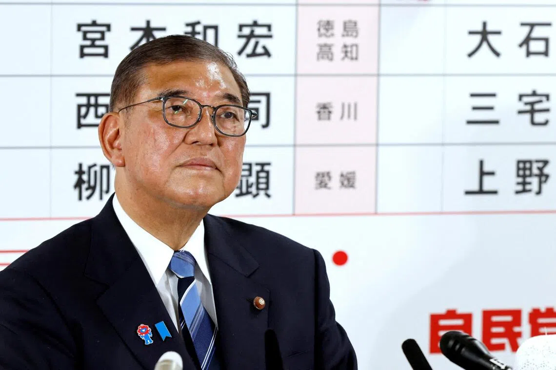 Japanese Prime Minister Shigeru Ishiba listens to a question from a journalist at the Liberal Democratic Party headquarters on July 20.