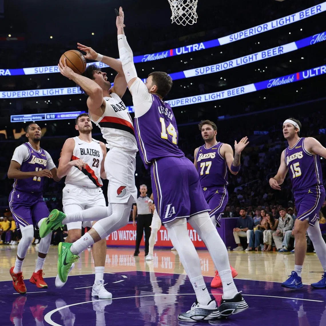 Deni Avdija of the Portland Trail Blazers attempting a shot in front of Walker Kessler of the Los Angeles Lakers during the first half on Oct 27 in Los Angeles.