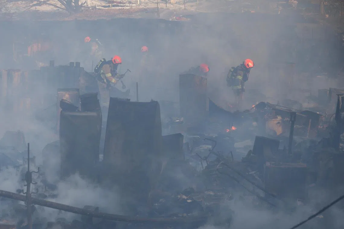 Firefighters work at the scene of a fire at Guryong village, the last slum in the glitzy Gangnam district, in Seoul, South Korea, on Jan 20, 2023. 