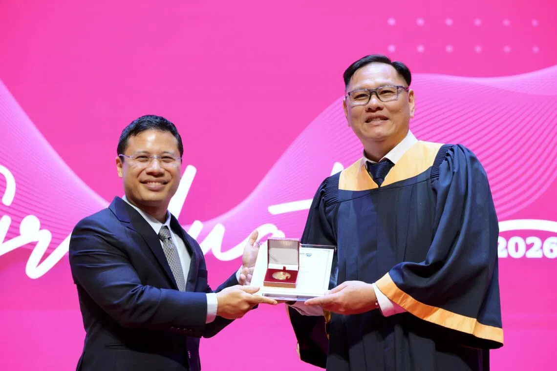 Mr Peter Wang (right) and Education Minister Desmond Lee on May 4.