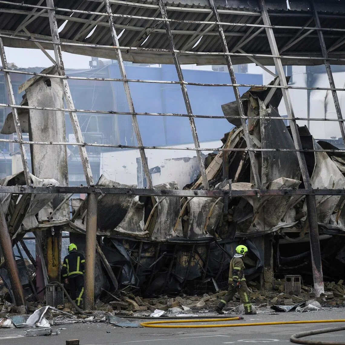 Ukrainian rescuers working at the site of a Russian missile strike on a hypermarket in Kyiv, Ukraine, on Oct 22.