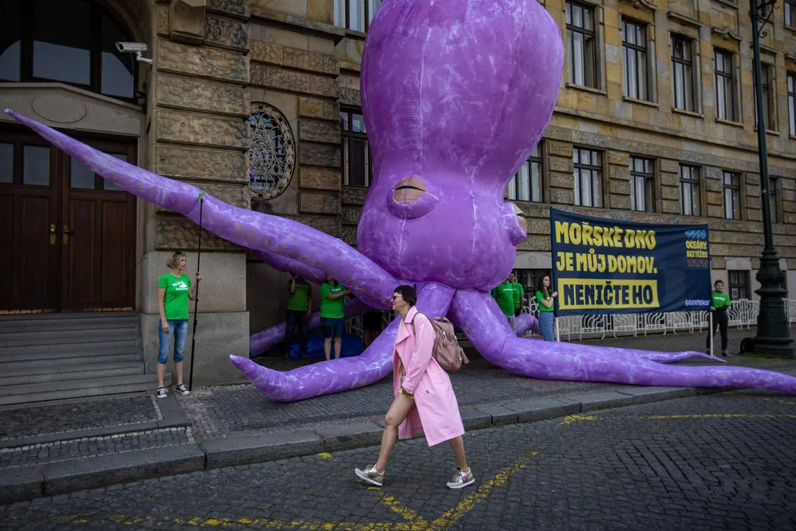 A giant inflated 'Ghost Octopus' is placed by activists of the environment protection organization 'Greenpeace' in front of the Czech Ministry of Industry and Trade to protest against deep sea mining, in Prague, Czech Republic, on June 1, 2023.