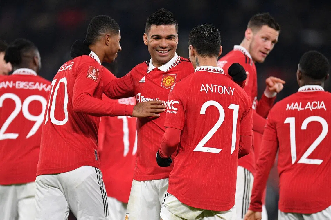 Manchester United midfielder Casemiro (centre) celebrates with teammates after scoring their second goal.