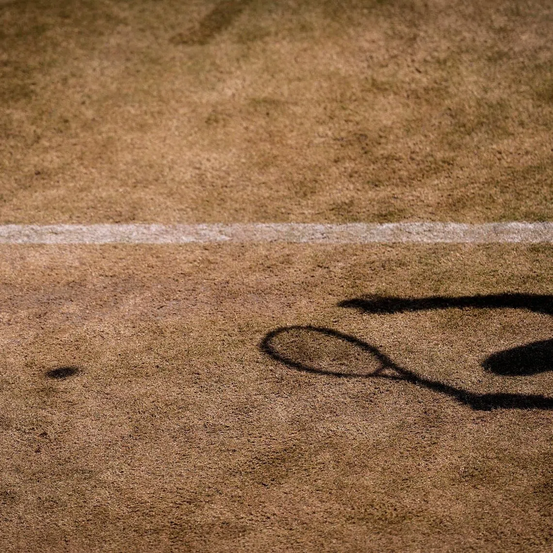 FILE PHOTO: The shadow of a player is pictured during a tennis match. London, Britain July 6, 2026. REUTERS/Andrew Couldridge/File photo