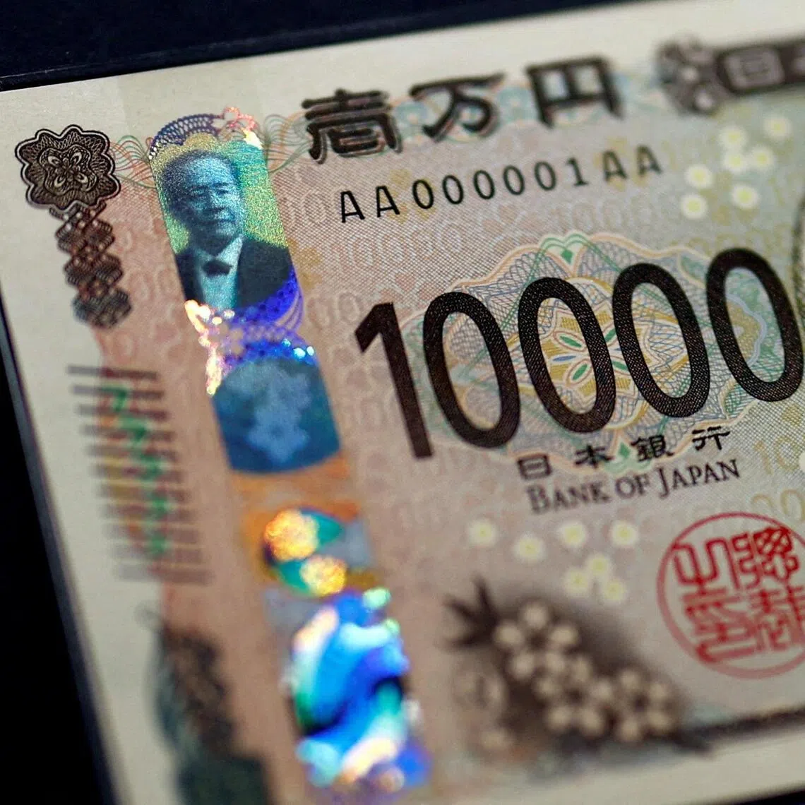 FILE PHOTO: Holograms, which show different images and colours depending on the angle at which they are viewed, are seen on the new Japanese 10,000 yen banknote as the new note is displayed at a currency museum of the Bank of Japan, on the day the new notes of 10,000 yen, 5,000 yen and 1,000 yen went into circulation, in Tokyo, Japan July 3, 2024. REUTERS/Issei Kato/Pool/File Photo