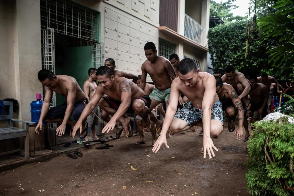 Recovering drug addicts exercise during a rehabilitation program at the Metta Saneain drug addict rehab centre in Yangon. 