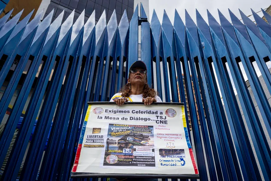 A protester calling for an election schedule and the return of leader and Venezuelan opposition leader Maria Corina Machado in Caracas, on Sept 28.