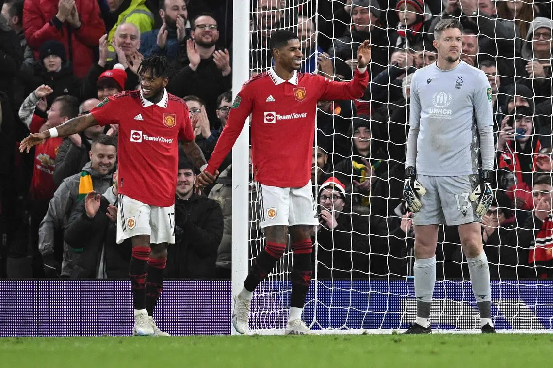 Manchester United's Brazilian midfielder Fred (L) celebrates scoring the team's second goal with Manchester United's English striker Marcus Rashford during the English League Cup semi-final second-leg  football match between Manchester United and Nottingham Forest at Old Trafford in Manchester, north west England, on February 1, 2023. (Photo by Paul ELLIS / AFP) / RESTRICTED TO EDITORIAL USE. No use with unauthorized audio, video, data, fixture lists, club/league logos or 'live' services. Online in-match use limited to 120 images. An additional 40 images may be used in extra time. No video emulation. Social media in-match use limited to 120 images. An additional 40 images may be used in extra time. No use in betting publications, games or single club/league/player publications. / 