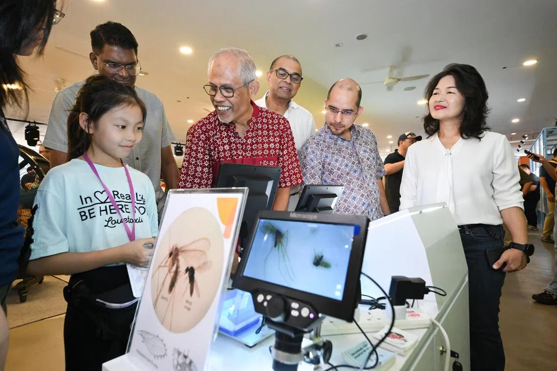 (3rd from left onwards) Grassroots Adviser for Tampines West Masagos Zulkifli, Senior Minister of State for Sustainability and the Environment Janil Puthucheary, Grassroots Adviser for Nee Soon Link Syed Harun Alhabsyi and ⁠Grassroots Adviser for Serangoon Chan Hui Yuh interacts with the public at the Project Wolbachia 10th Anniversary Community Carnival on Oct 31.