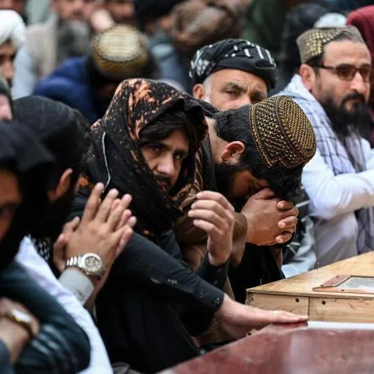 Afghan mourners attending a mass funeral prayer for victims killed by a Pakistani airstrike that struck a drug rehabilitation centre, at the Eid Gah Mosque in Kabul on March 26, 2026.