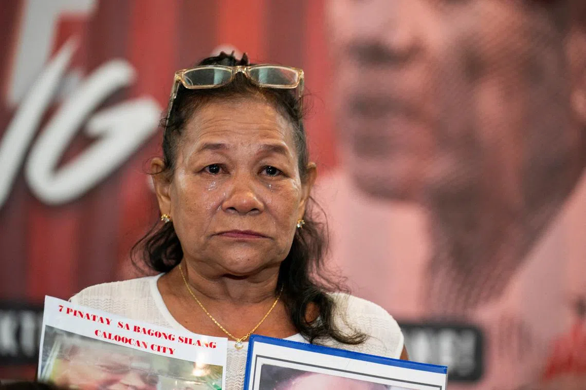 A woman hold pictures of her son who was a victim of the drug war and extrajudicial killing, during a press conference following the arrest of former Philippine President Rodrigo Duterte, in Quezon City, Metro Manila, Philippines, March 12, 2025. REUTERS/Lisa Marie David