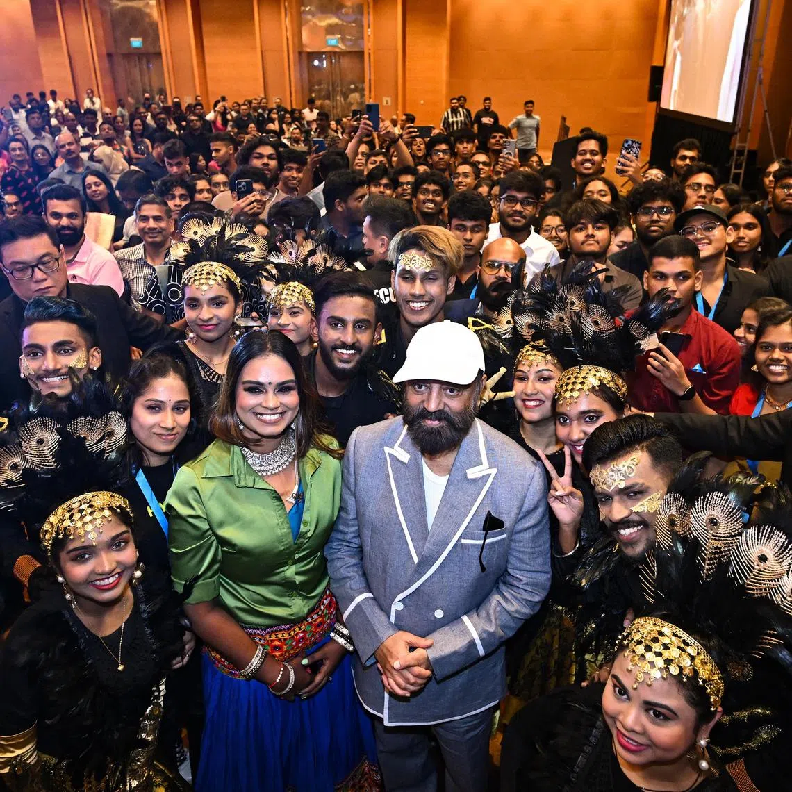 Star Kamal Hassan (in white cap) taking a group photograph with performers and fans during a fans meet event for upcoming movie Indian 2. 