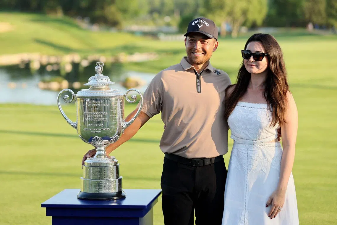 Xander Schauffele poses with his wife, Maya Schauffele, and the Wanamaker Trophy after winning the 2024 PGA Championship at Valhalla Golf Club on May 19, 2024.