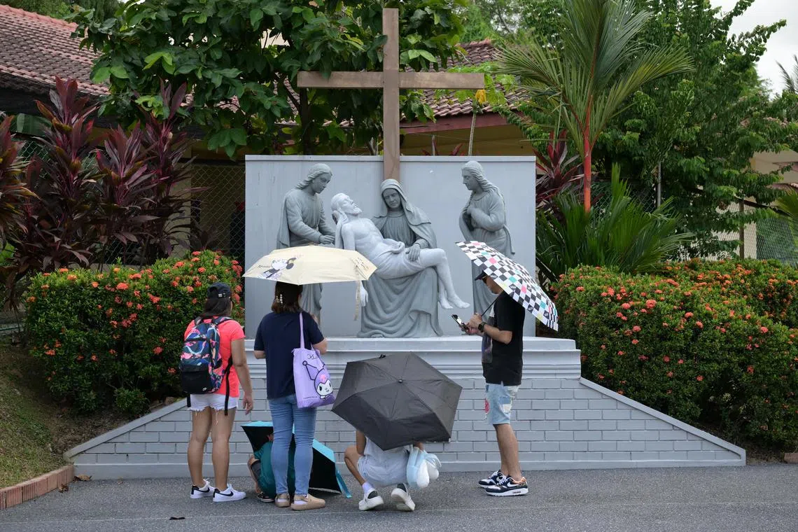 Worshippers at the thirteen section of the Stations of the Cross, Jesus is taken down from the cross at St. Joseph's Church (Bukit Timah ) on Good Friday, March 29, 2024. The Way of the Cross is a special prayer across 14 stations, with each station depicting an event that took place during Jesus's journey to Mount Calvary where he was crucified. 