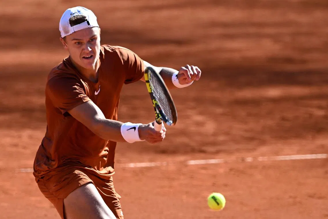 Denmark's Holger Rune returns the ball to Chile's Cristian Garin in Munich, on April 21, 2023.