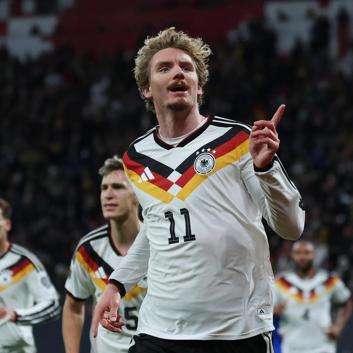 Nick Woltemade of Germany celebrates after scoring against Slovakia in a World Cup qualifier.