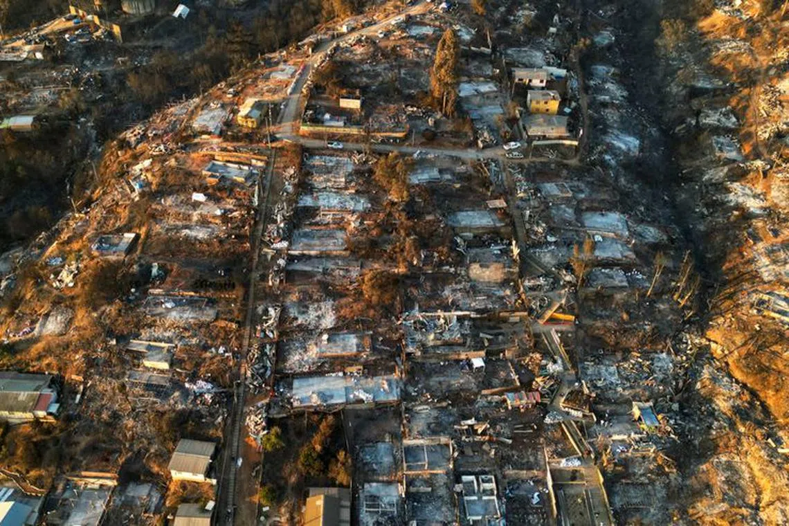 An aerial view shows the remains of houses burnt following the spread of wildfires in Vina del Mar, Chile February 5, 2024. REUTERS/Rodrigo Garrido/File Photo