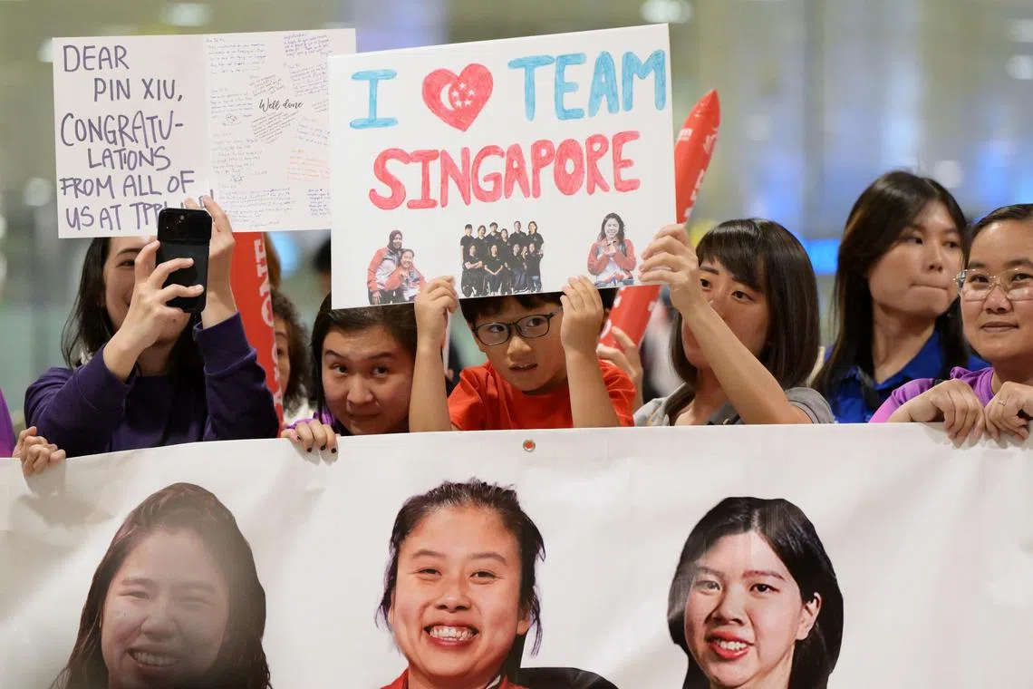 Caleb Tan welcoming Singapore Paralympians with other supporters. The young boy was at Changi Airport when Singapore Olympian Max Maeder returned to Singapore and is present today as well to receive the Team Singapore Paralympics contingent.