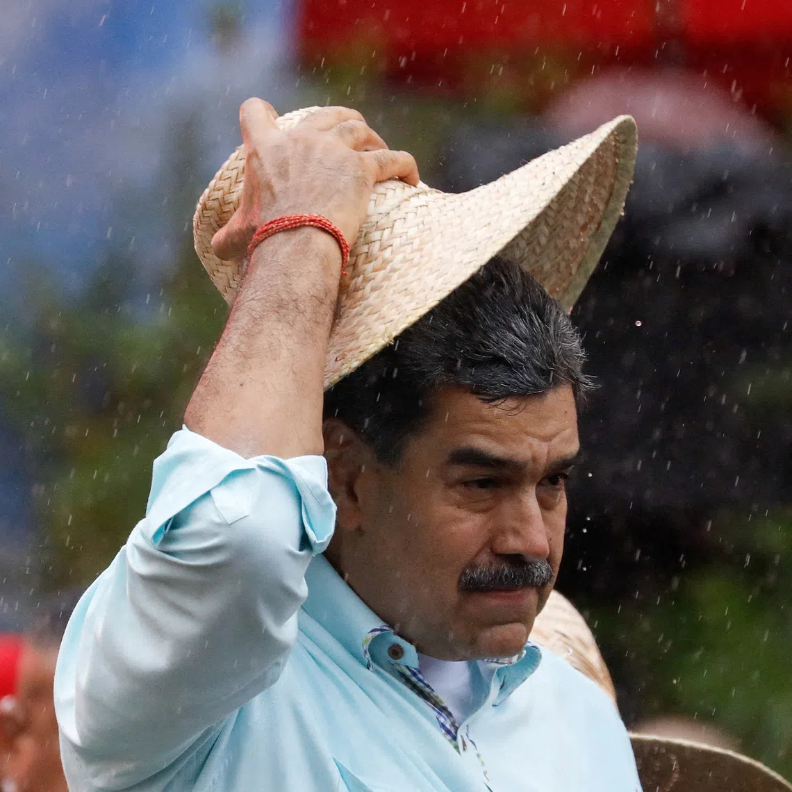 FILE PHOTO: Venezuela's President Nicolas Maduro holds a hat as he joins his supporters during a march in Caracas, Venezuela, December 10, 2025. REUTERS/Leonardo Fernandez Viloria/File Photo