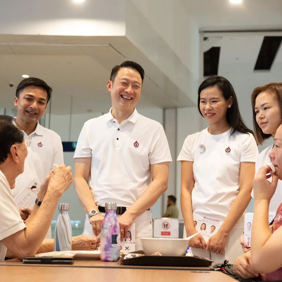 PAP's Sengkang GRC candidates Elmie Nekmat, Lam Pin Min, Bernadette Giam and Theodora Lai chatting with residents at Buangkok Hawker Centre.