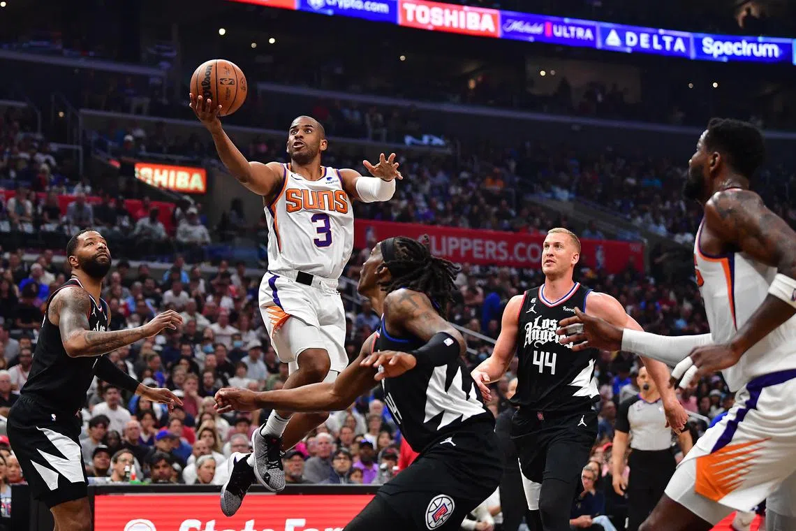 Phoenix Suns guard Chris Paul drives to the basket against Los Angeles Clippers forward Marcus Morris during the NBA play-offs.