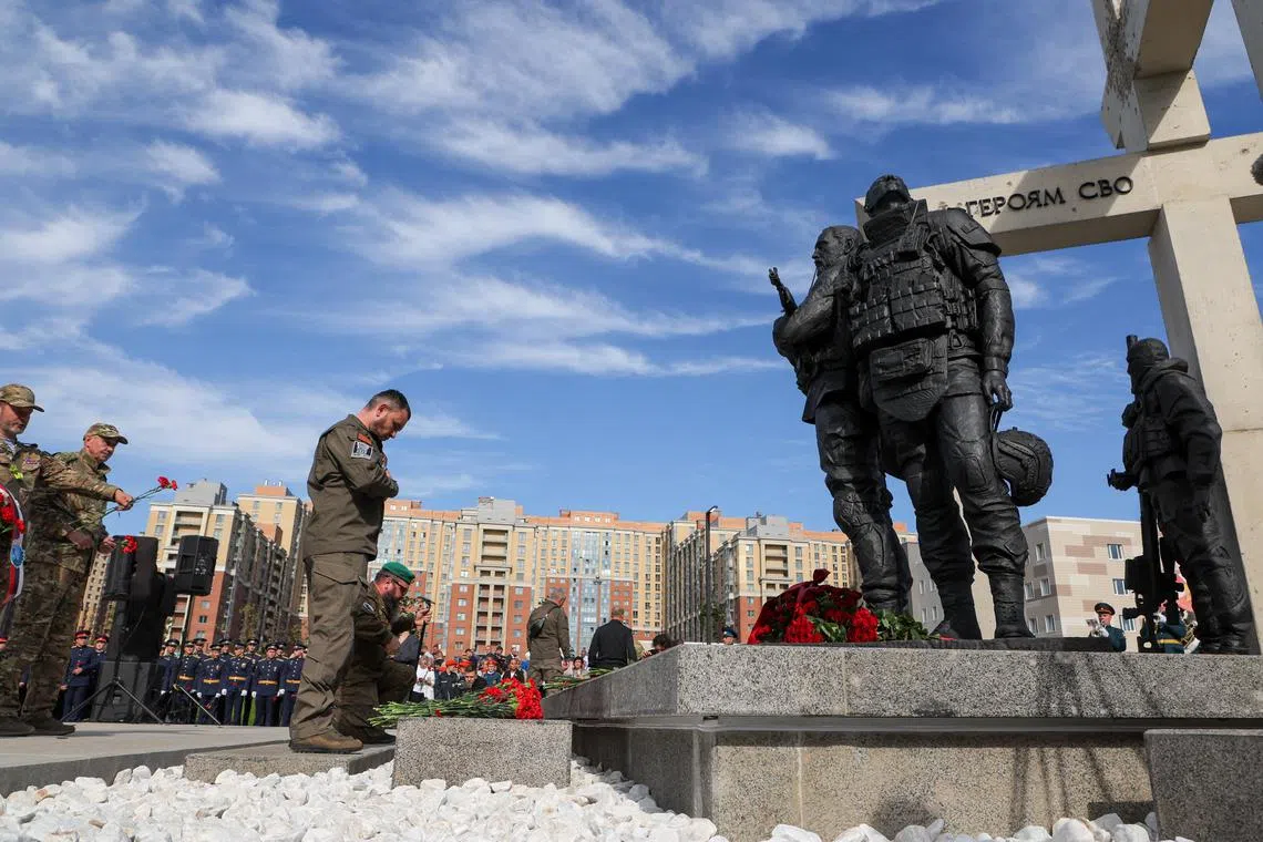 People attend a ceremony unveiling a monument \"To heroes of Special Military Operation\", erected to pay respect to members of the Russian armed forces involved in a military conflict against Ukraine, in the town of Kudrovo outside Saint Petersburg, Russia September 12, 2025. REUTERS/Anton Vaganov