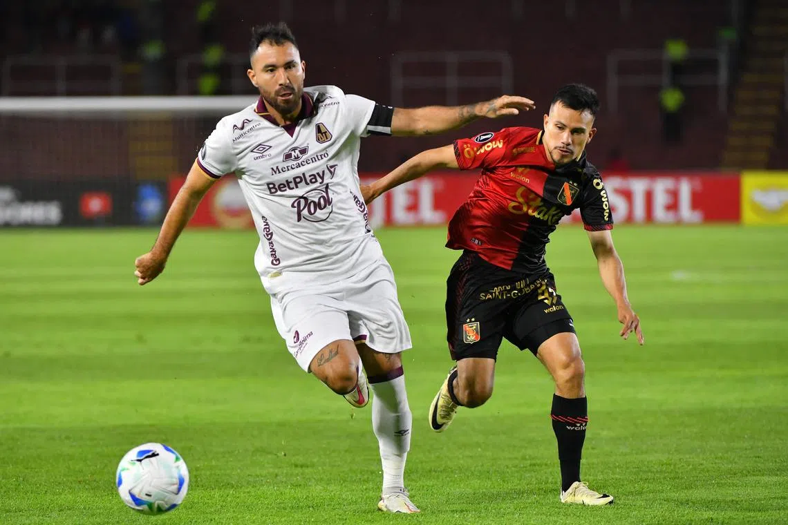 Colombian team Deportes Tolima's midfielder Pablo Nieto (left) and Peruvian side Melgar's midfielder Walter Tandazo fight for the ball in the Copa Libertadores qualification second round second leg football match at the UNSA Monumental Stadium in Arequipa, Peru, on Feb 27, 2025.
