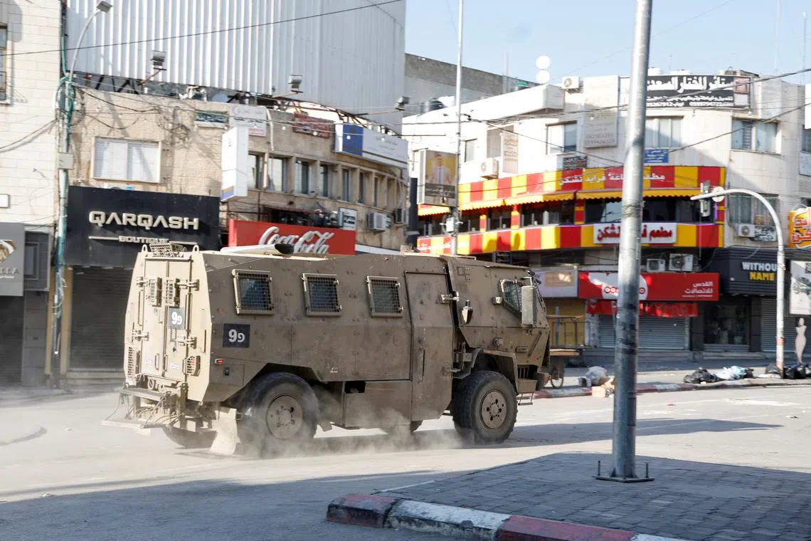 A military vehicle manoeuvres during an Israeli raid in Jenin, in the Israeli-occupied West Bank, June 6, 2024. REUTERS/Raneen Sawafta