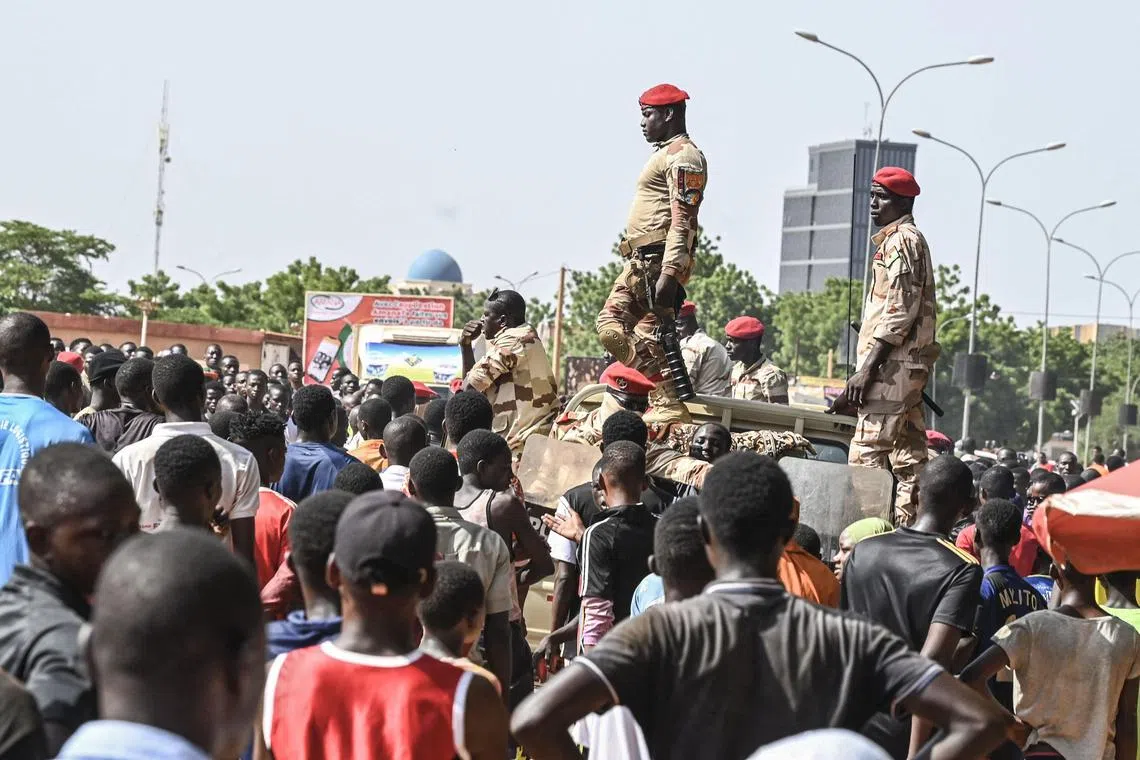 Volunteers gather near a stadium in Niger's capital, Niamey, to be registered as civilian auxiliaries who could potentially mobilise in support of the armed forces. 