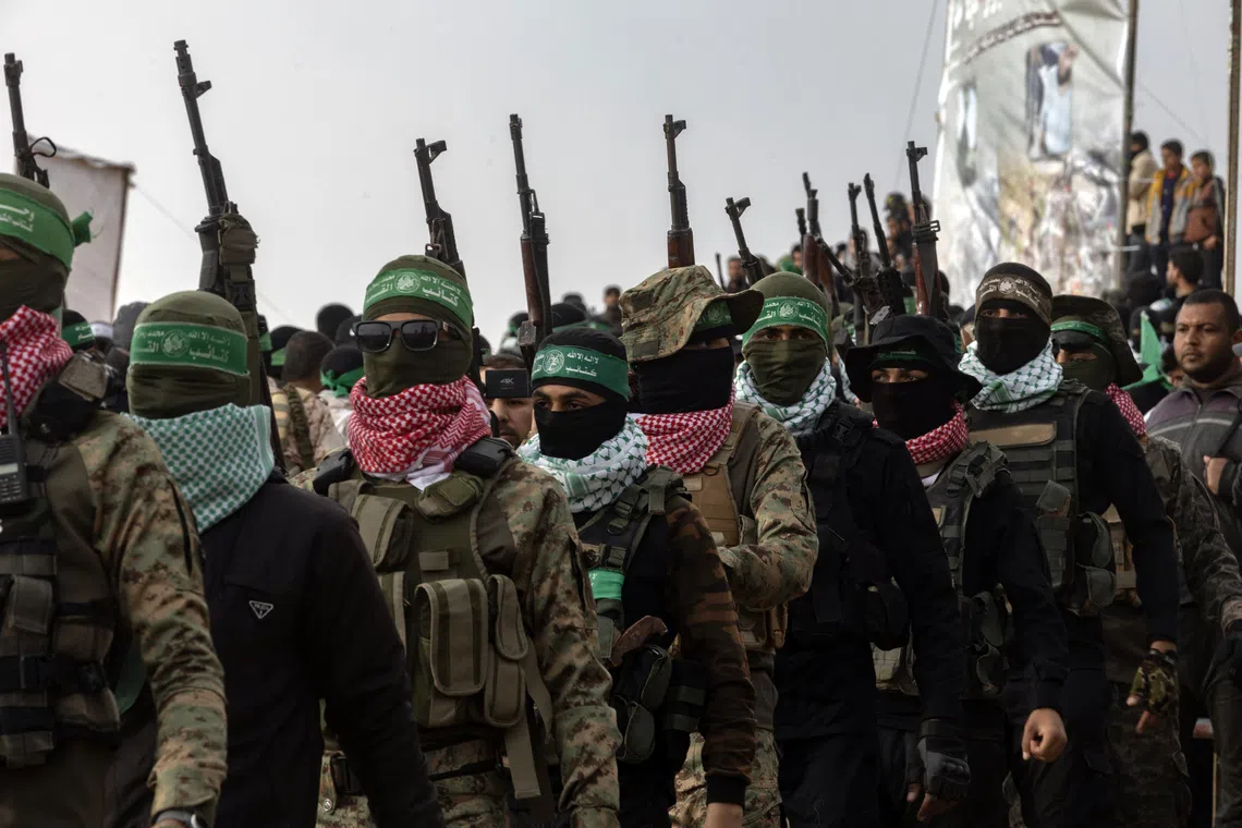 Members of Hamas during the transfer of four bodies of Israeli hostages to the Red Cross in Khan Younis, Gaza, on Feb 20.
