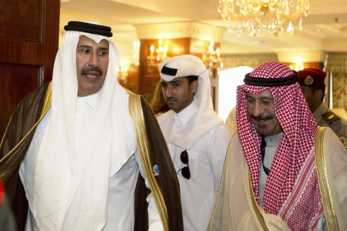 Qatari Prime Minister and Minister of Foreign Affairs Sheikh Hamad Bin Jassim al Thani (L) walks with former Minister of Foreign Affairs Sheikh Mohammed al Salem al Sabah, ahead of the opening ceremony of the first International Conference of Council for Arab and International Relations in Kuwait City February 11, 2013. REUTERS/Stephanie Mcgehee/file photo