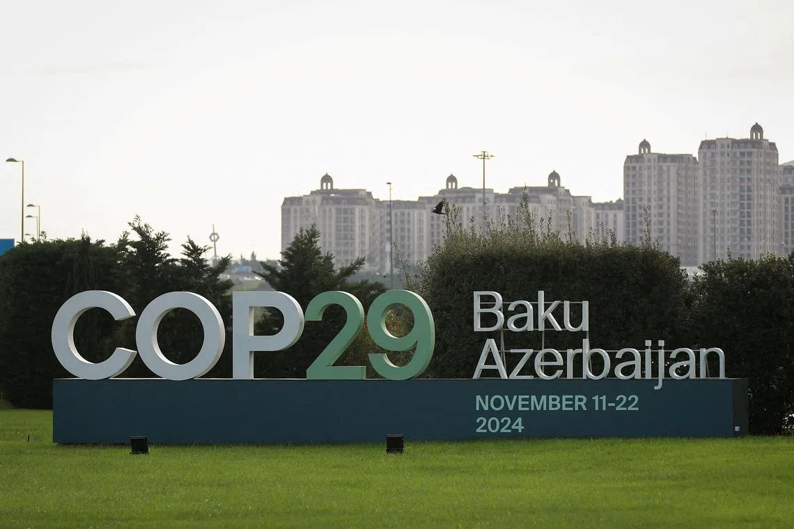 FILE PHOTO: A view shows a sign of the COP29 United Nations Climate Change Conference with a backdrop of the cityscape in Baku, Azerbaijan October 31, 2024. REUTERS/Aziz Karimov/File Photo