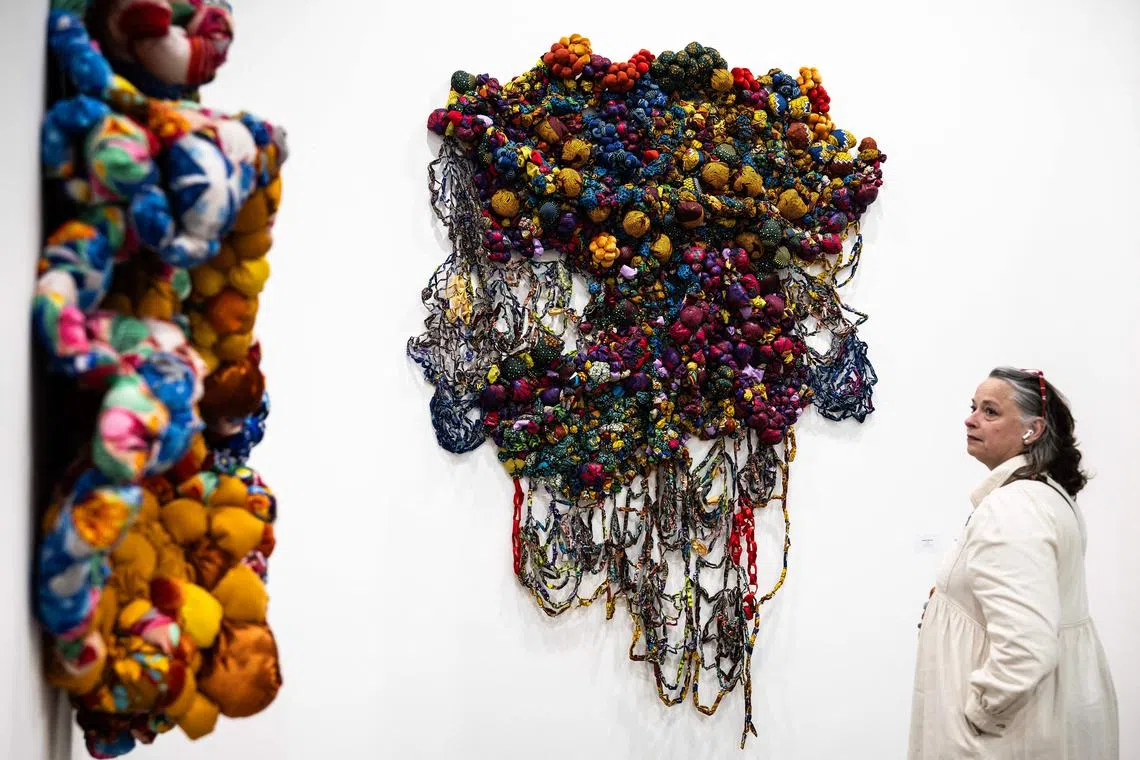 A visitor looking at an art installation by Nigerian artist Samuel Nnorom, entitled Obianuju, during the 'Artissima' art fair at Oval Lingotto, in Turin, Italy, on Oct 31, 2024. 
