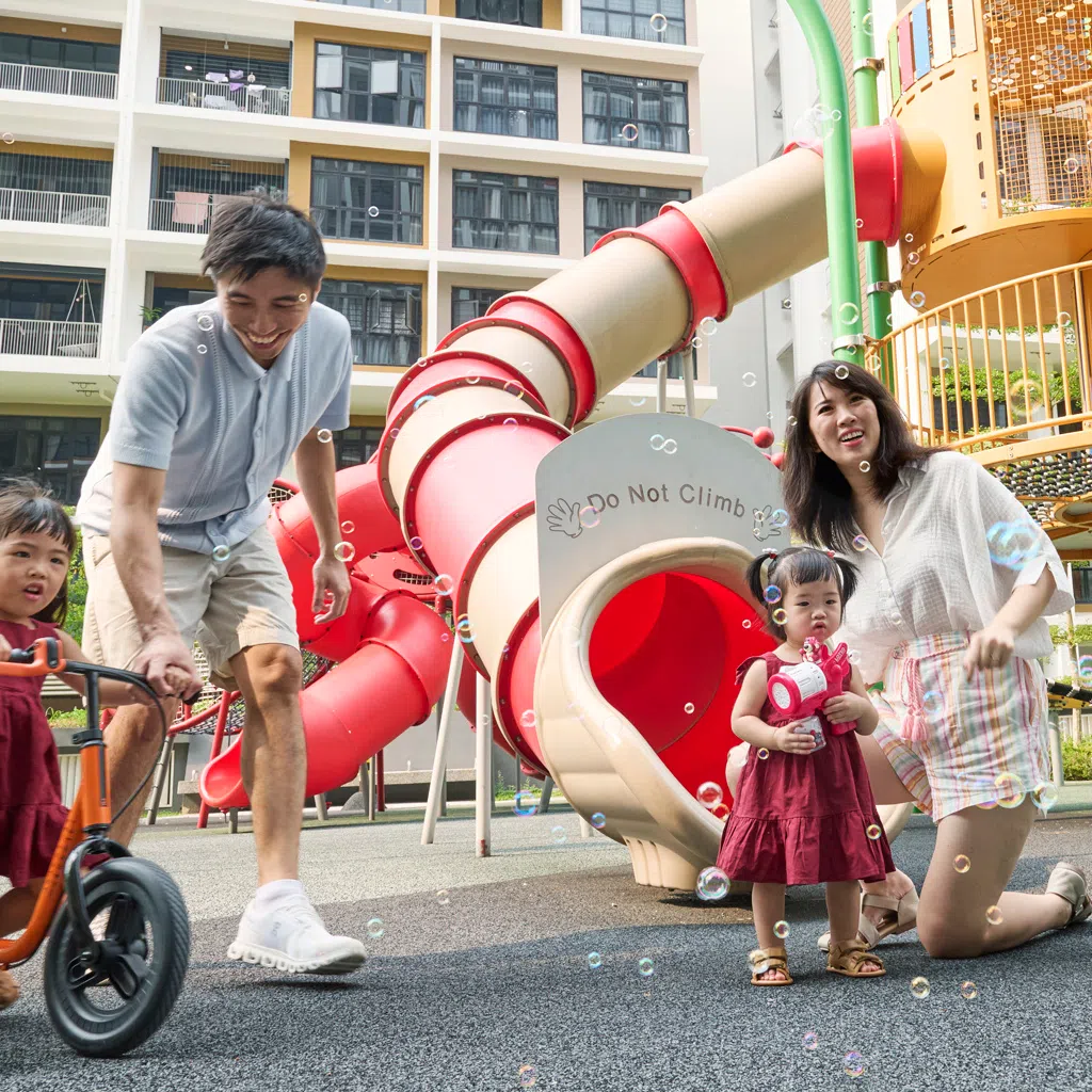 Jorene Lee, her husband Stanley Ong and their daughters Alysson (on bicycle) and Audelia near their Garden Vale @ Tengah home.