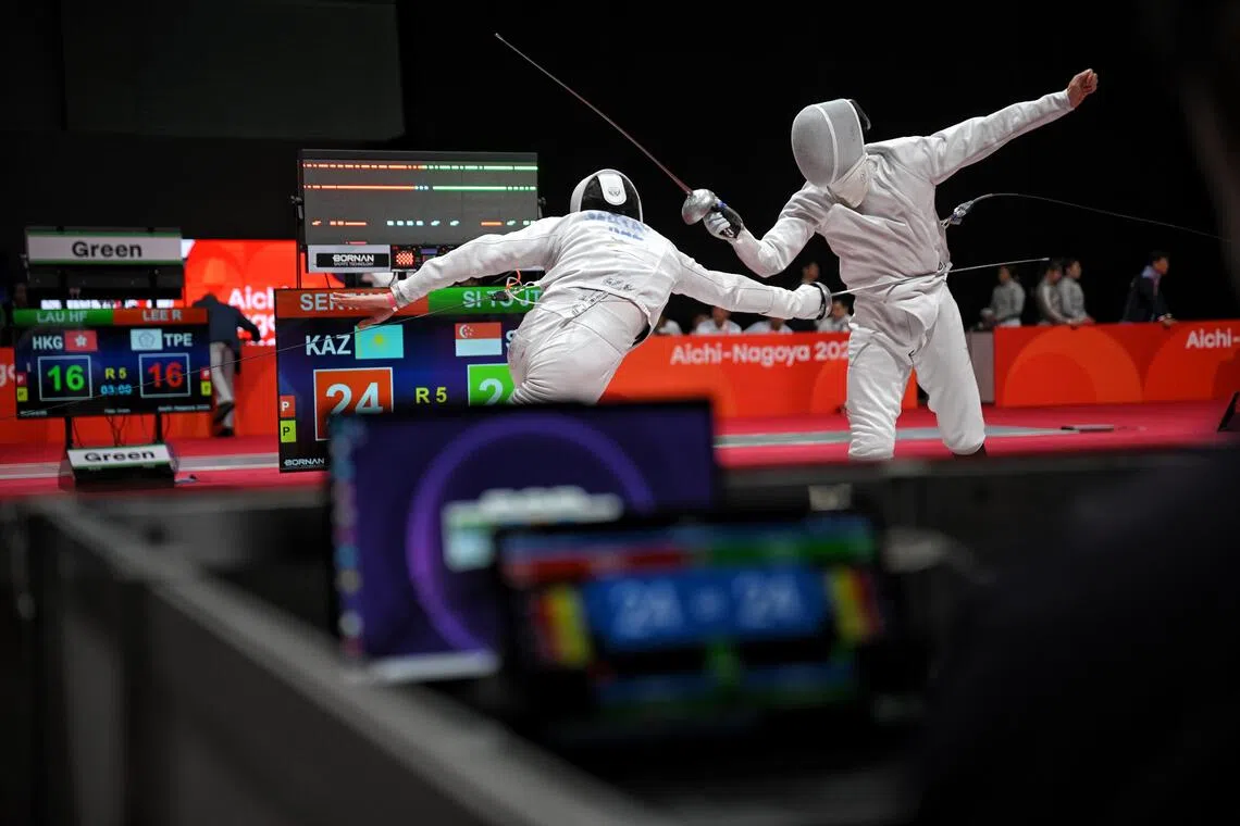 Sertay Yerlik of Kazakhstan (left) and Singapore’s Si To Jian Tong in action during the Asian Games men’s epee team quarter-finals on Sept 27.