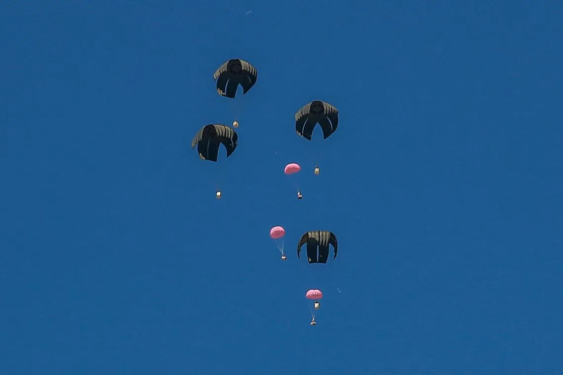 Aid parcels are airdropped over the northern Gaza Strip on March 8 amid the ongoing conflict between Israel and the Hamas movement.