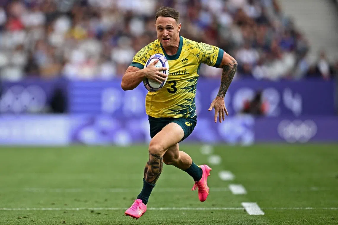 FILE PHOTO: Paris 2024 Olympics - Rugby Sevens - Men's Pool B - Australia vs Kenya - Stade de France, Saint-Denis, France - July 24, 2024. Corey Toole of Australia scores their third try REUTERS/Dylan Martinez/File Photo
