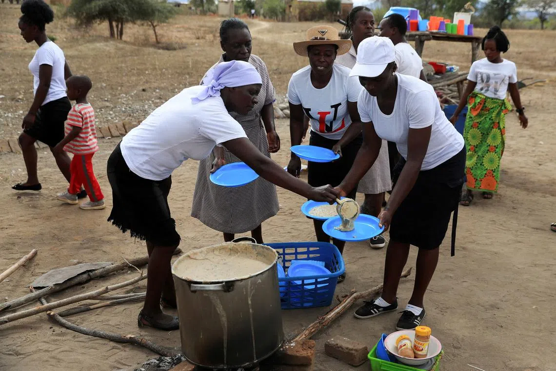 FILE PHOTO: A woman serves traditional porridge at a rural home, as Zimbabwe is experiencing an El Nino-induced drought, resulting in malnutrition among children under the age of five, pregnant and lactating women, and adolescents, in Kotwa in Mudzi district, Zimbabwe July 2, 2024. REUTERS/Philimon Bulawayo/File Photo