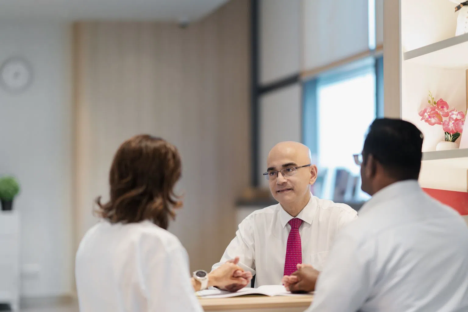 IVF specialist Dr Suresh Nair speaking with patients