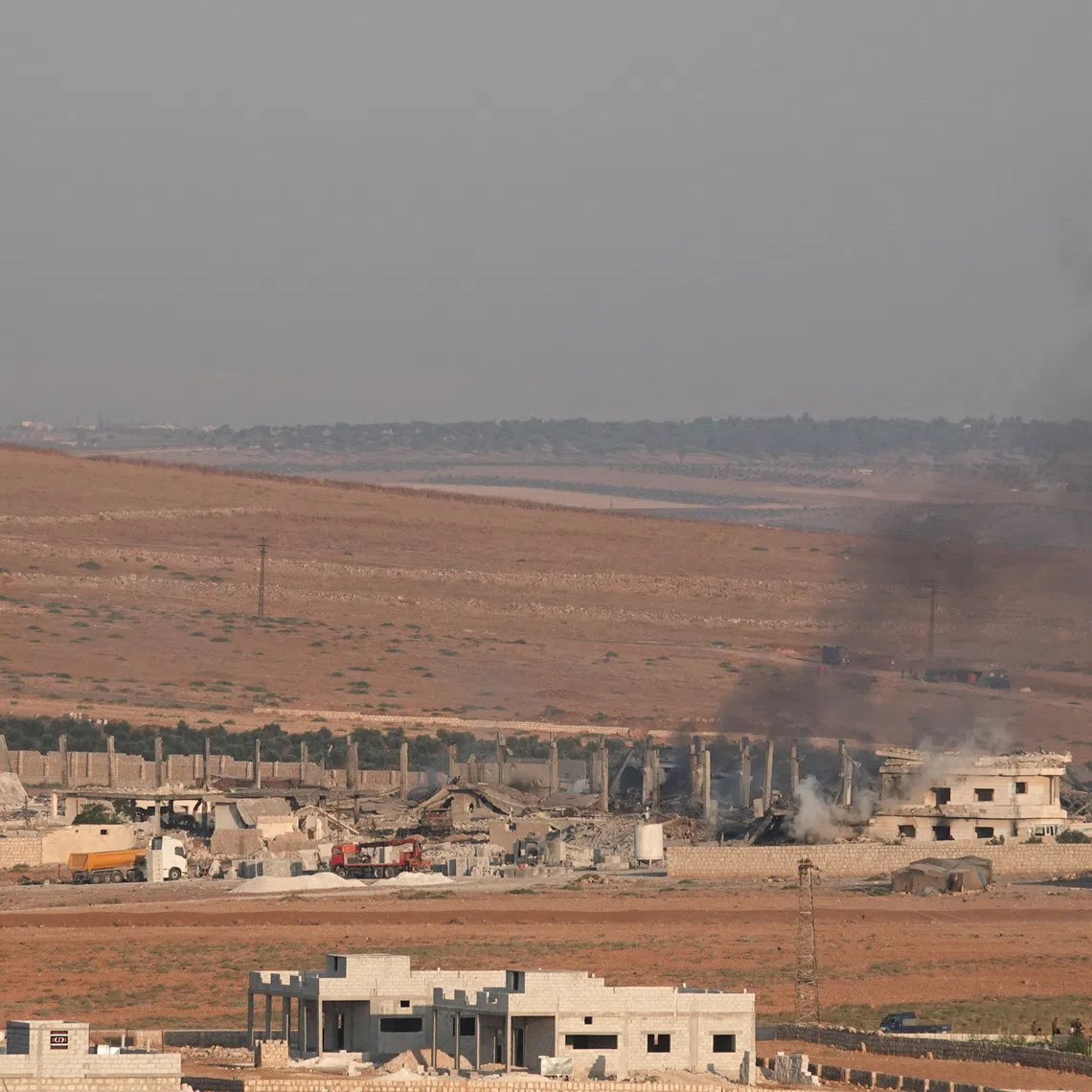 Smoke rises from a weapons depot following an explosion in the Al-Eis area, in the southern countryside of Aleppo, Syria, September 21, 2026. REUTERS/Karam al-Masri