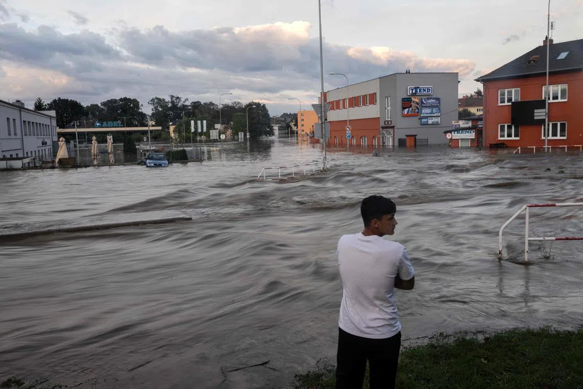 A man looks at a flooded street in Czech Republic amid swathes of Austria, the Czech Republic, Hungary, Romania and Slovakia have been hit by high winds and unusually fierce rainfall. 