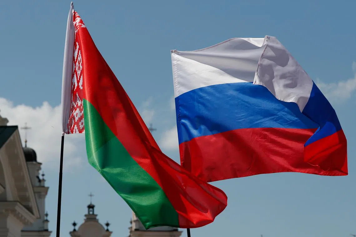 FILE PHOTO: Belarusian and Russian national flags fly in central Minsk, Belarus June 8, 2019.  REUTERS/Vasily Fedosenko/File Photo