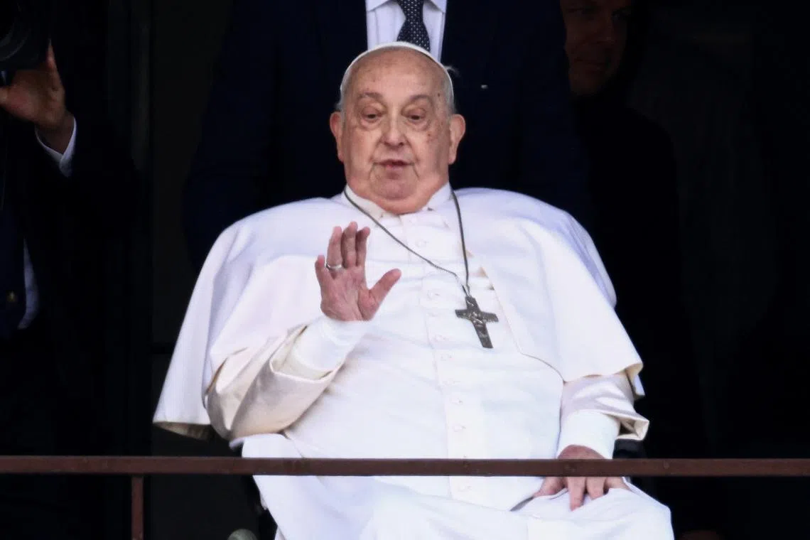 Pope Francis gestures during his first public appearance in five weeks, on the day he is set to be discharged from Gemelli Hospital, in Rome, Italy, March 23, 2025. REUTERS/Guglielmo Mangiapane/File Photo