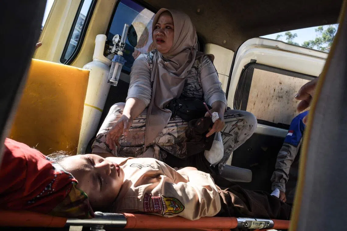 A student receiving treatment inside an ambulance after suffering from food poisoning at Cisarua Junior High School in Bandung, West Java, on Oct 14, 2025. 
