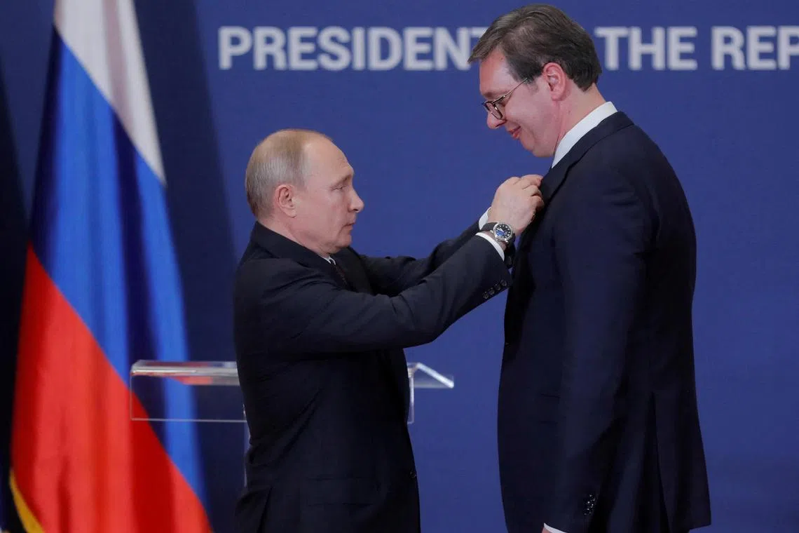 A 2019 photo shows Russian President Vladimir Putin (left) awarding Serbian President Aleksandar Vucic with the Order of Alexander Nevsky, after a meeting in Belgrade, Serbia.